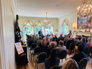 Governor Tony Evers talks in front of a crowd at the Governor's Residence