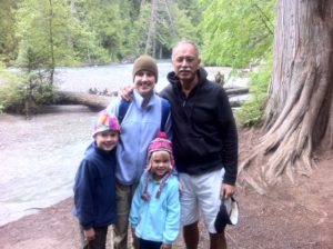 Photo of Todd C. Flynn and his family standing together outside. Clockwise from the top left are Laurie Lewis Robertson, Todd C. Flynn, and Robertson's two children