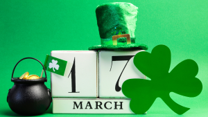 Image of a calendar turned to March 17 with a green background, pot of gold, green hat and shamrock