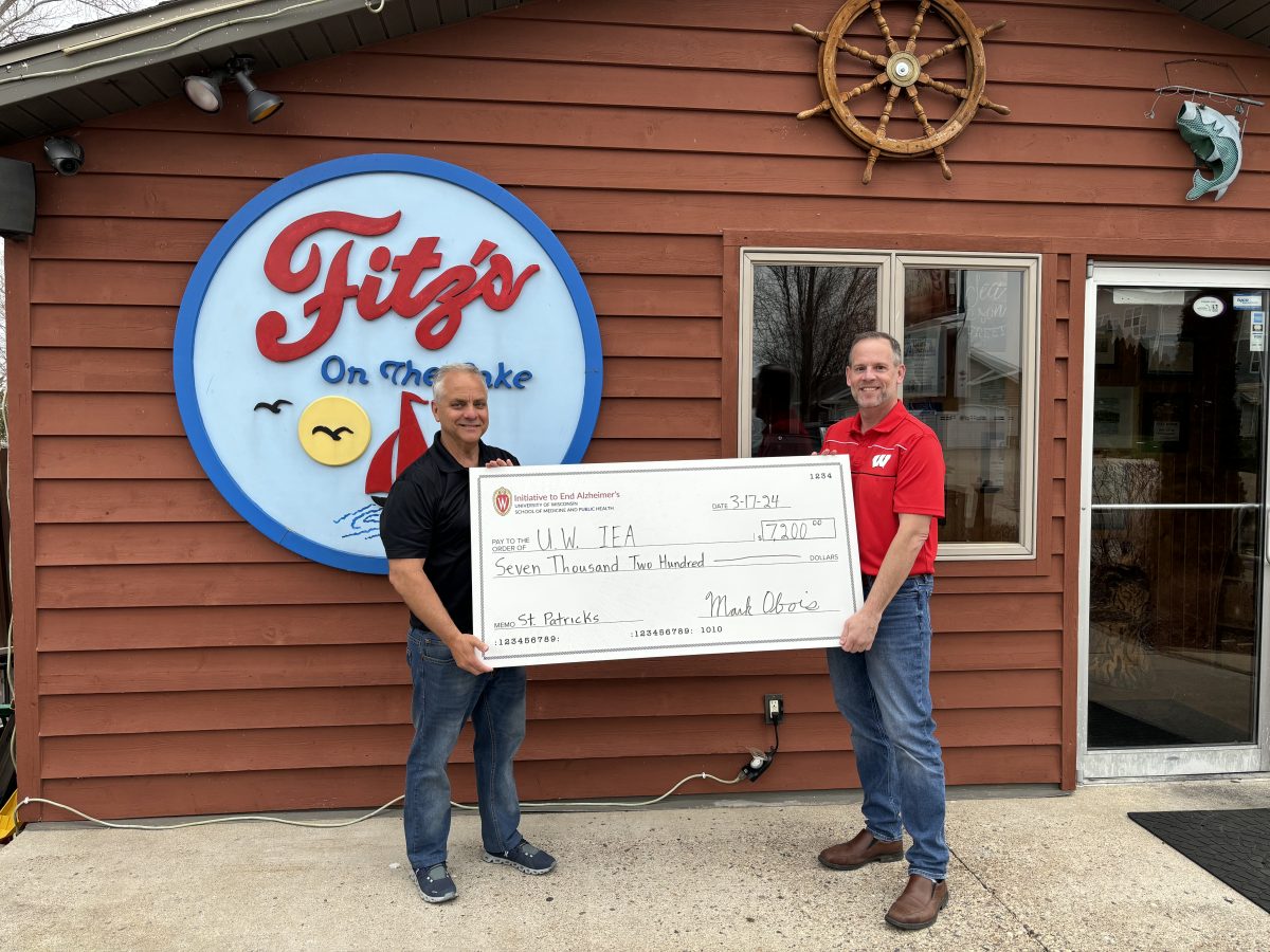 Mark Obois and Steve Ramig standing outside Fitz's on the Lake with a "big check" from their St. Patrick's Day 2024 fundraiser