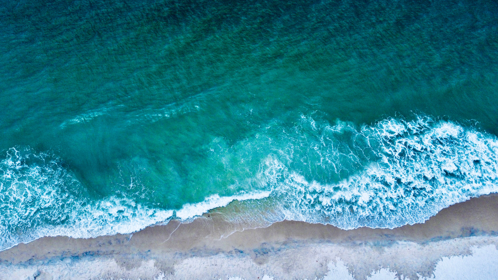 Ocean water washing ashore a beach in Naples, FL