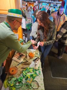 Steve Ramig, senior director of development, selling raffle tickets at Fitz's on the Lake Alzheimer's fundraiser, March 2025