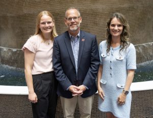 Three adults from UW Foundation Initiative to End Alzheimers stand together.