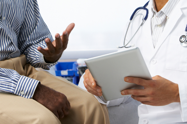 Person consulting with their doctor in a clinic setting